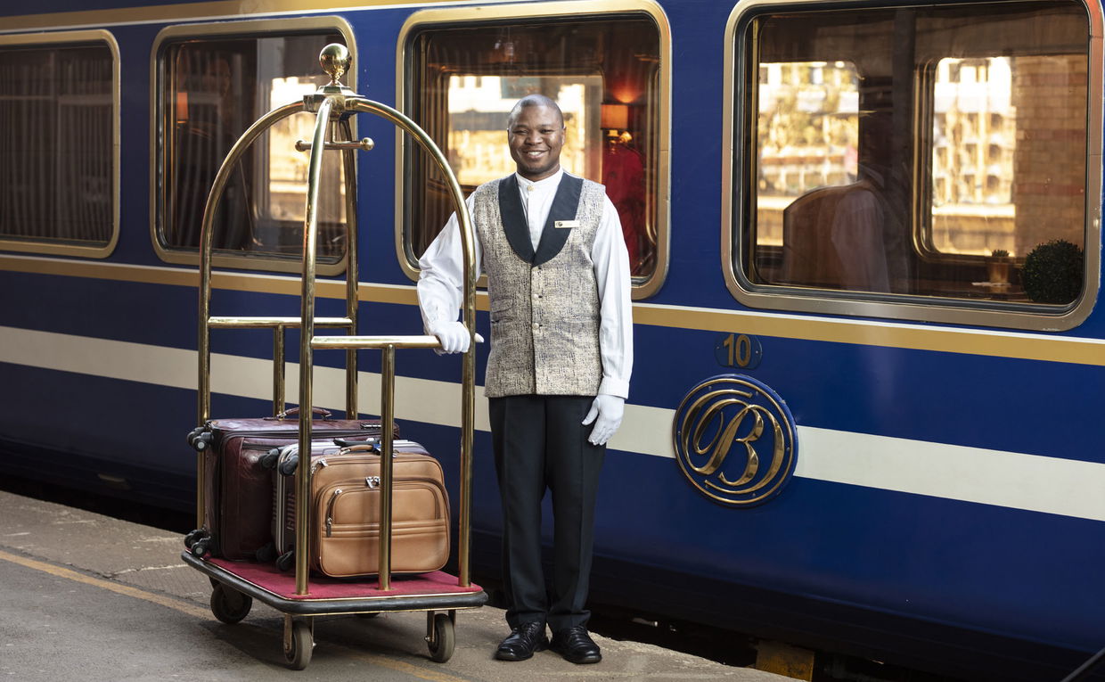 butler with luggage on platform of the blue train Pretoria butler with luggage on platform of the blue train Pretoria