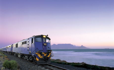Blue train locomotive at sunset with table mountain cape town in background Blue train locomotive at sunset with table mountain cape town in background