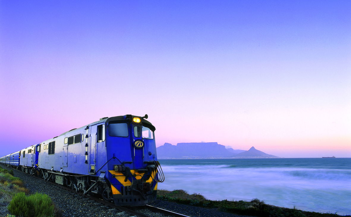 Blue train locomotive at sunset with table mountain cape town in background