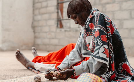 sangoma on a mat during a cultural visit at Thornybush