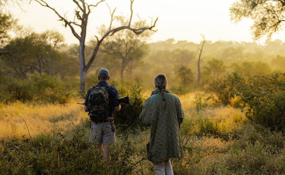 guide and guest early morning on a bush walk by Thornybush game lodge