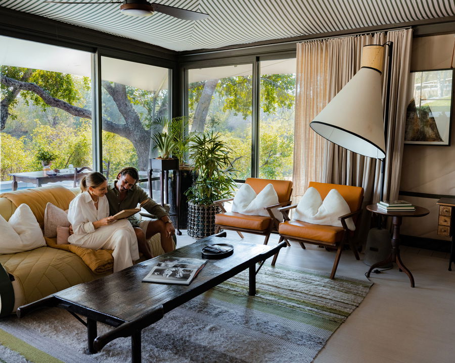 guests on couch in main area of little saseka tented camp thornybush