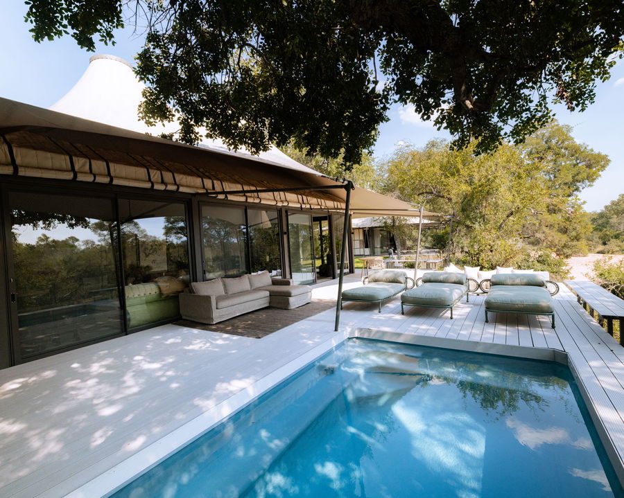 view of splash pool on deck of little saseka tented camp thornybush