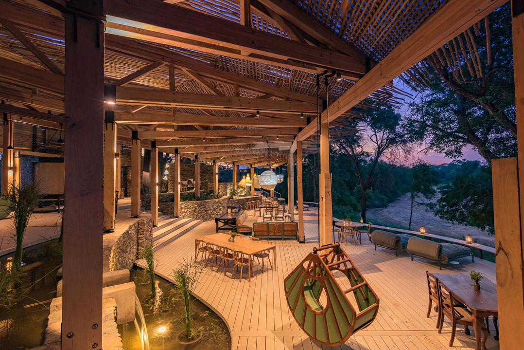 evening view of main viewing deck and seating area of lodge at saseka tented camp thornybush
