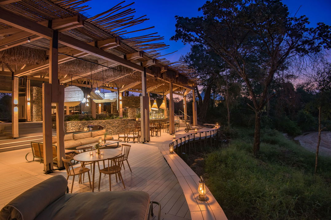 night view of main viewing deck and seating area of lodge at saseka tented camp thornybush