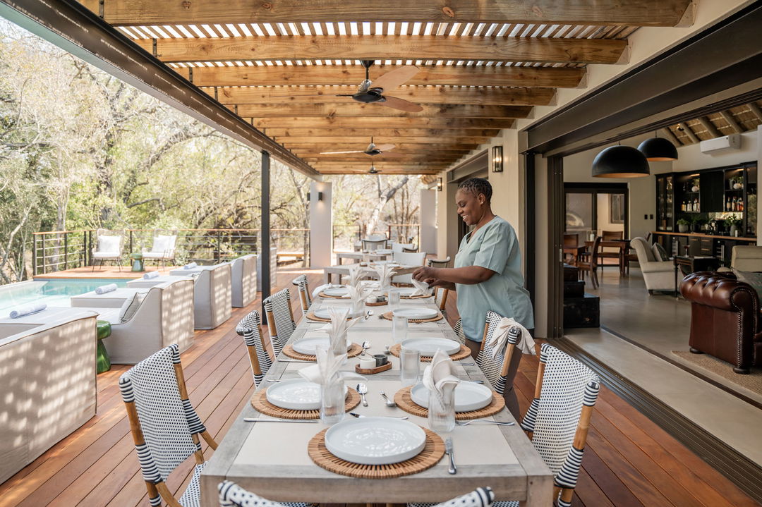 main dining area on deck getting ready for breakfast at thornybush simbambili lodge