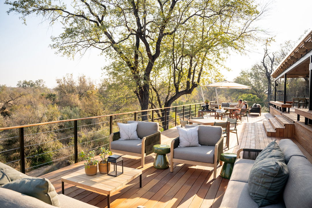 main deck area of lodge at simbambili thornybush next to river