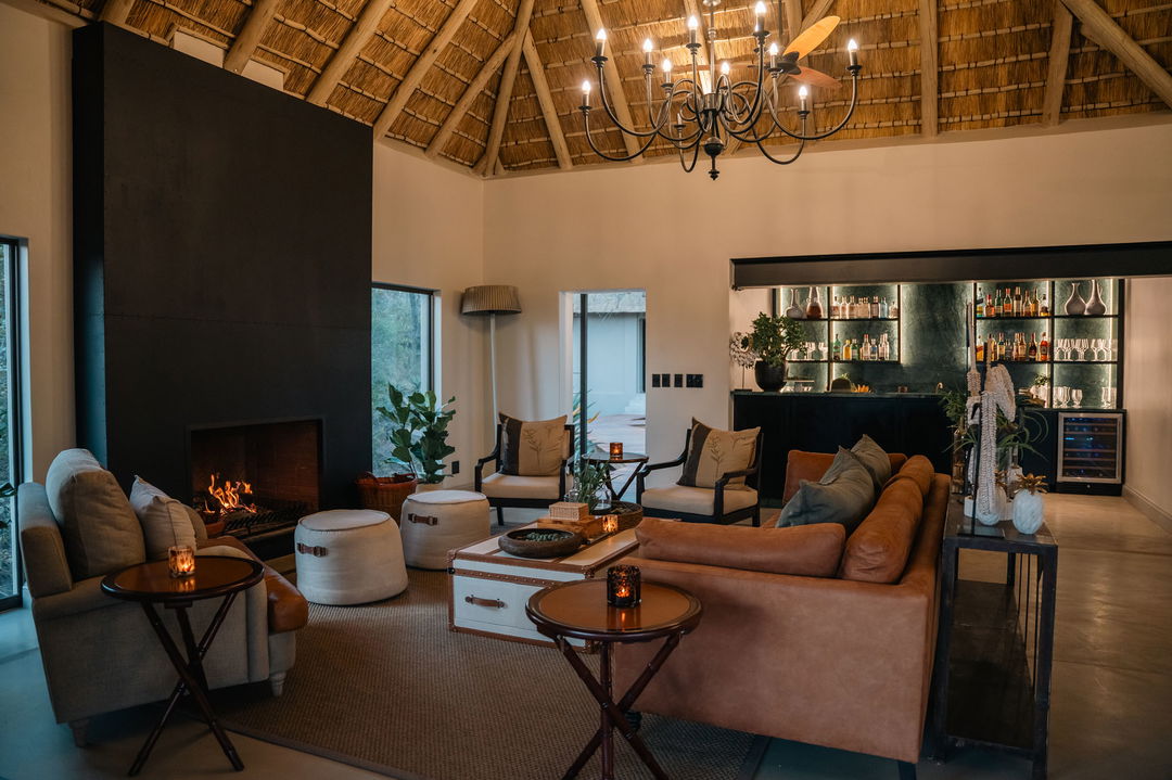 main area of lodge with seating and fireplace at simbambili lodge thornybush