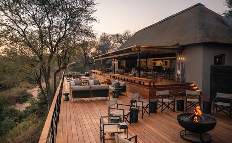 fireplace and dining area on deck of thornybush simbambili lodge at sunset fireplace and dining area on deck of thornybush simbambili lodge at sunset