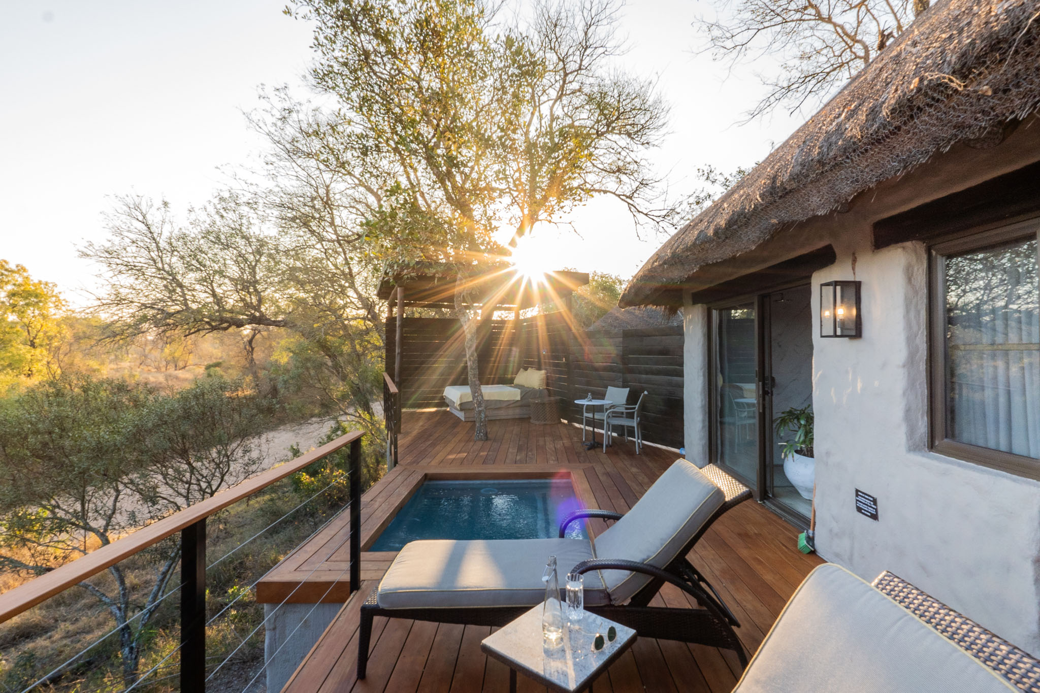 patio and deck view at sunset outside room at Simbambili lodge Thornybush