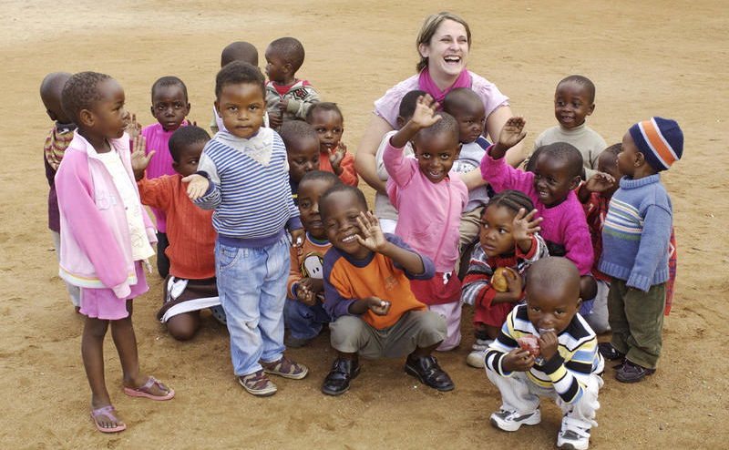 guest with local children during a community visit at ulusaba guest with local children during a community visit at ulusaba