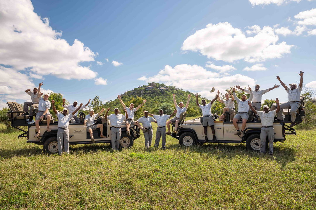 two safari vehicles with rangers celebrating at Ulusaba game reserve