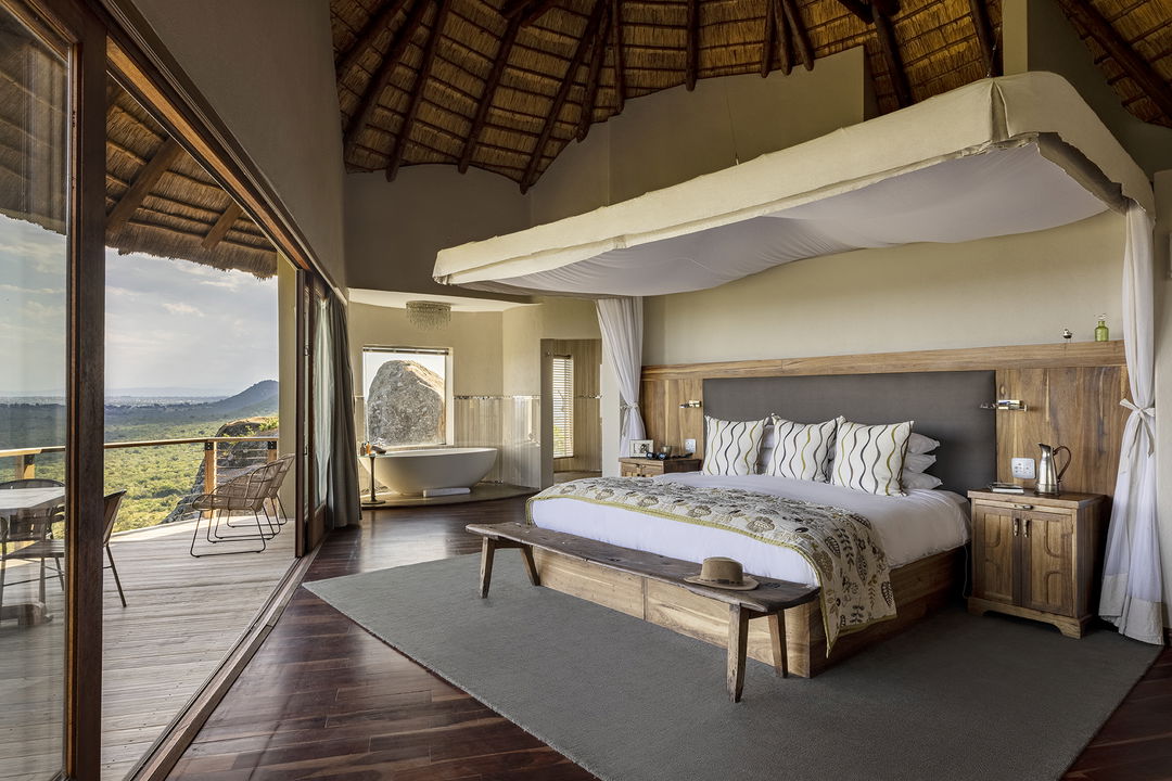 partial view from a luxury room and deck with valley below at Ulusaba cliff lodge