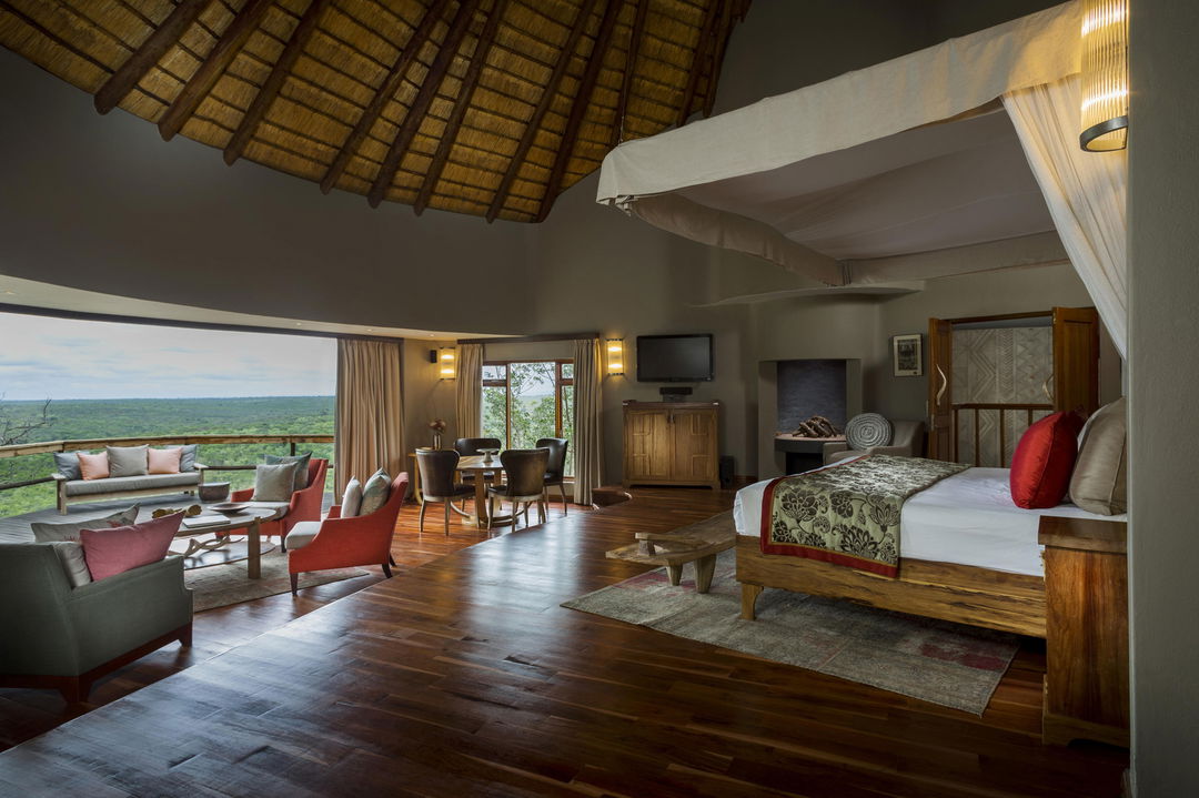 inside view of bedroom and deck with views at ulusaba cliff lodge