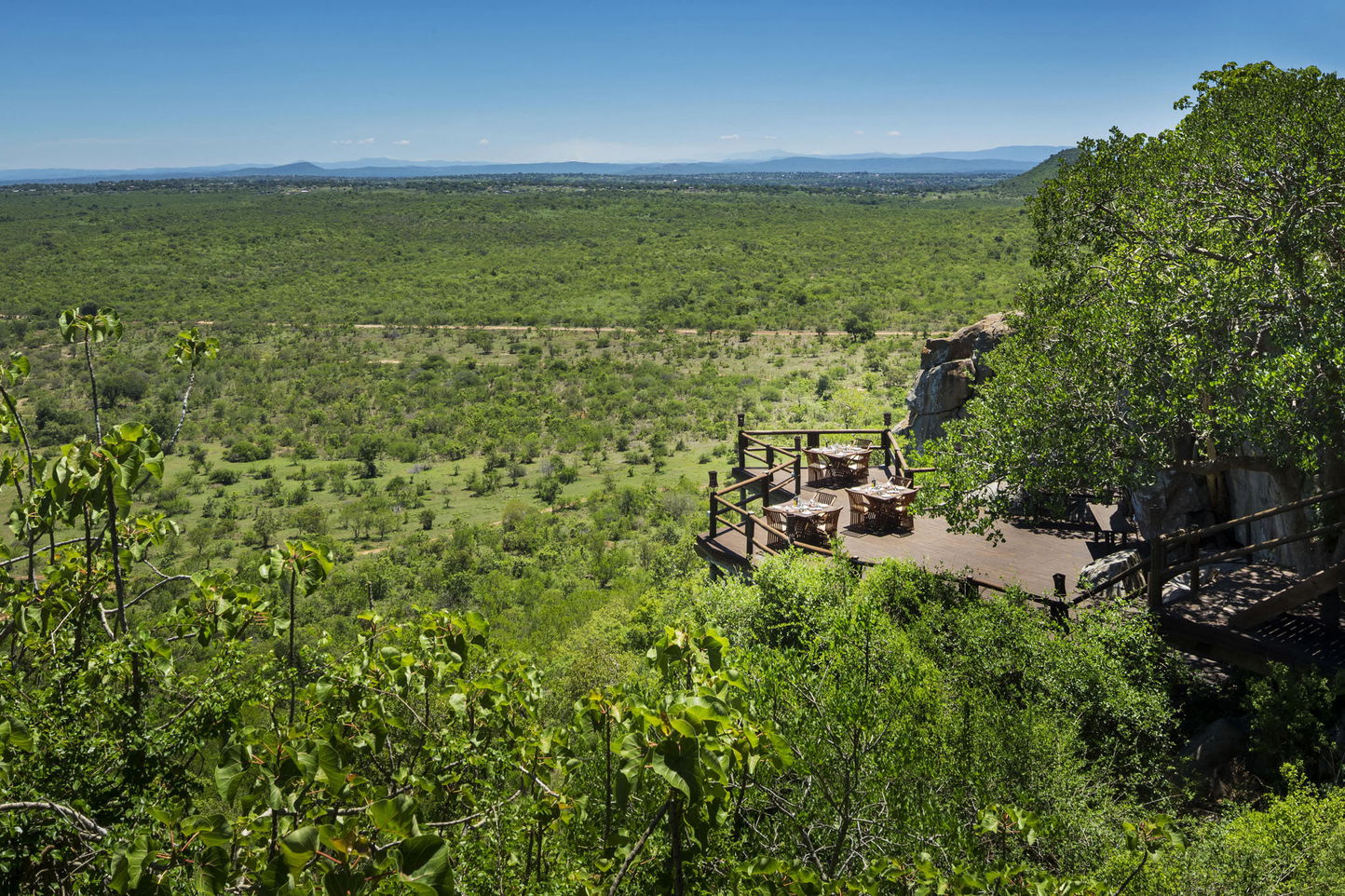table setting at side of cliff on deck of ulusaba rock lodge