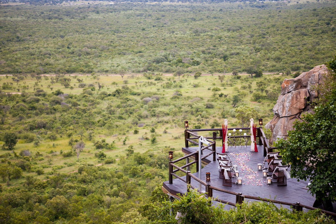 wedding setup on deck of Ulusaba cliff lodge with view of the valley below