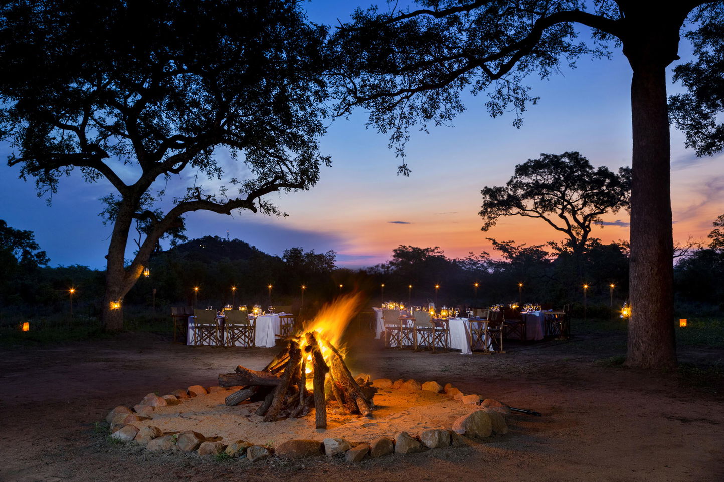 tables set at sunset for dinner in the bush at Ulusaba safari lodge