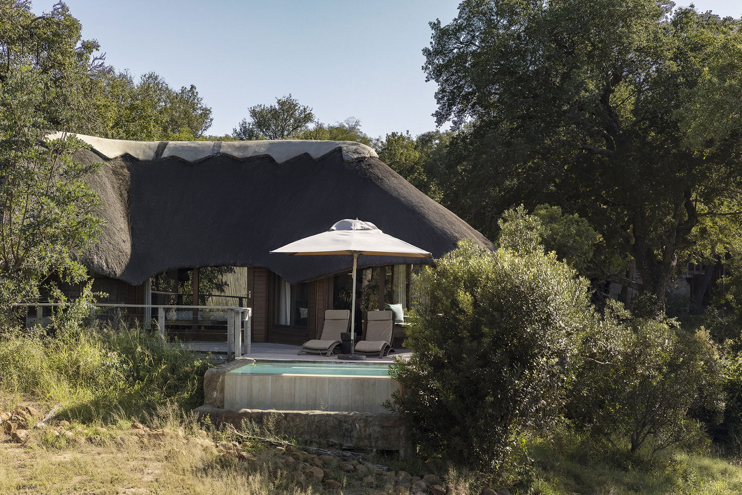 safari lodge room facing dry river in bush at Ulusaba