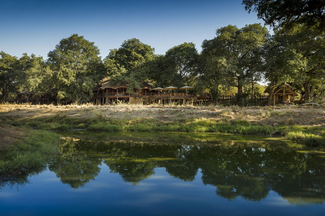 view of outside of ulusaba safari lodge across the dam in front