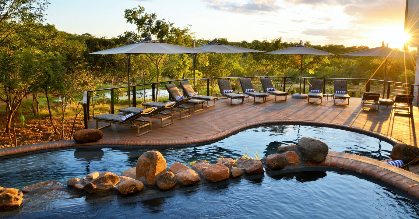raised pool deck with loungers at Victoria falls safari lodge Zimbabwe