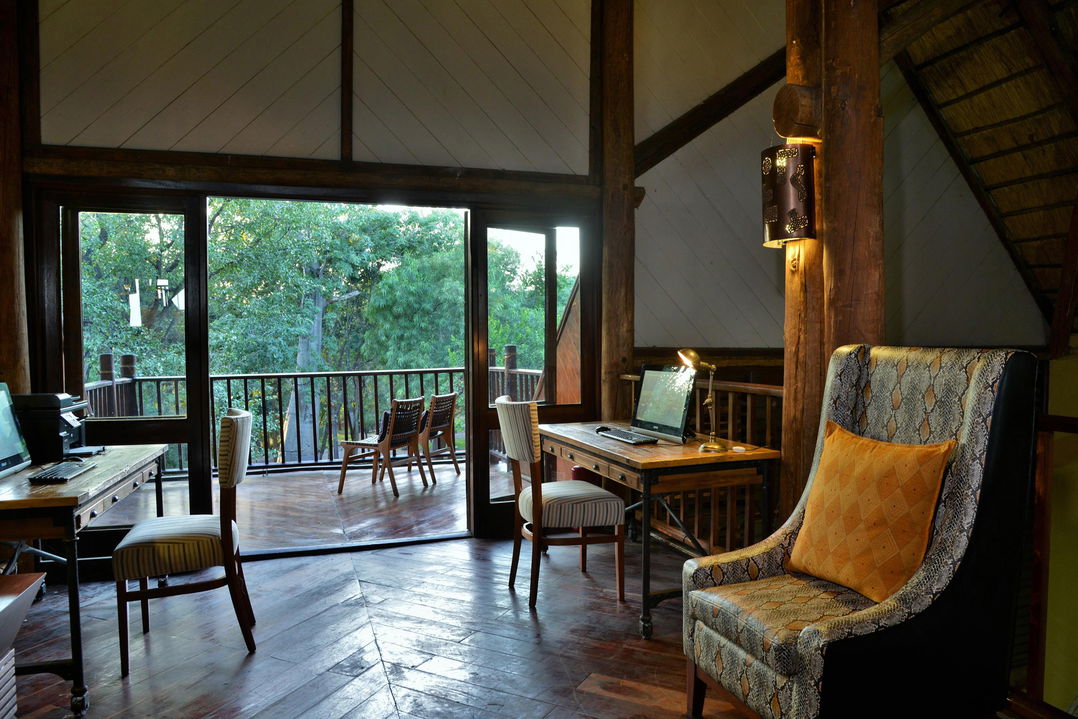 seating area with balcony from inside Victoria falls safari lodge bedroom
