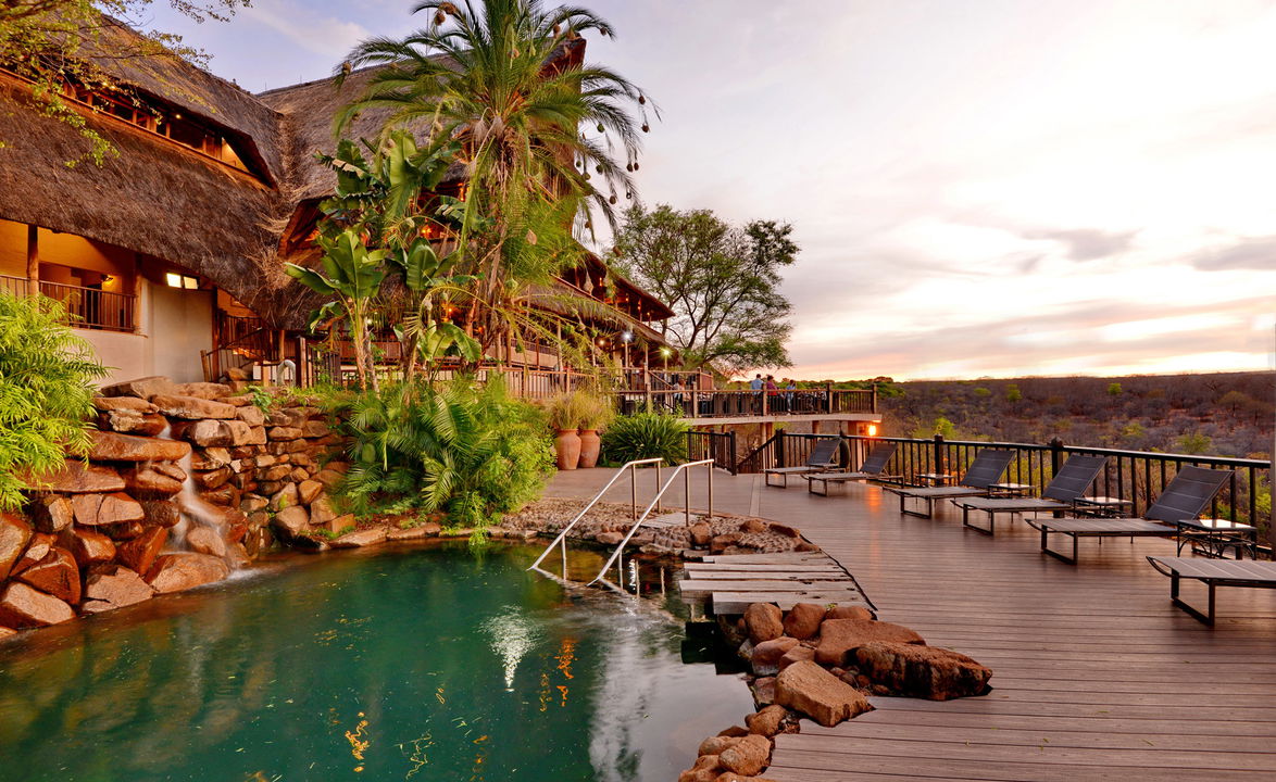 main pool and deck of Victoria falls safari lodge at sunset