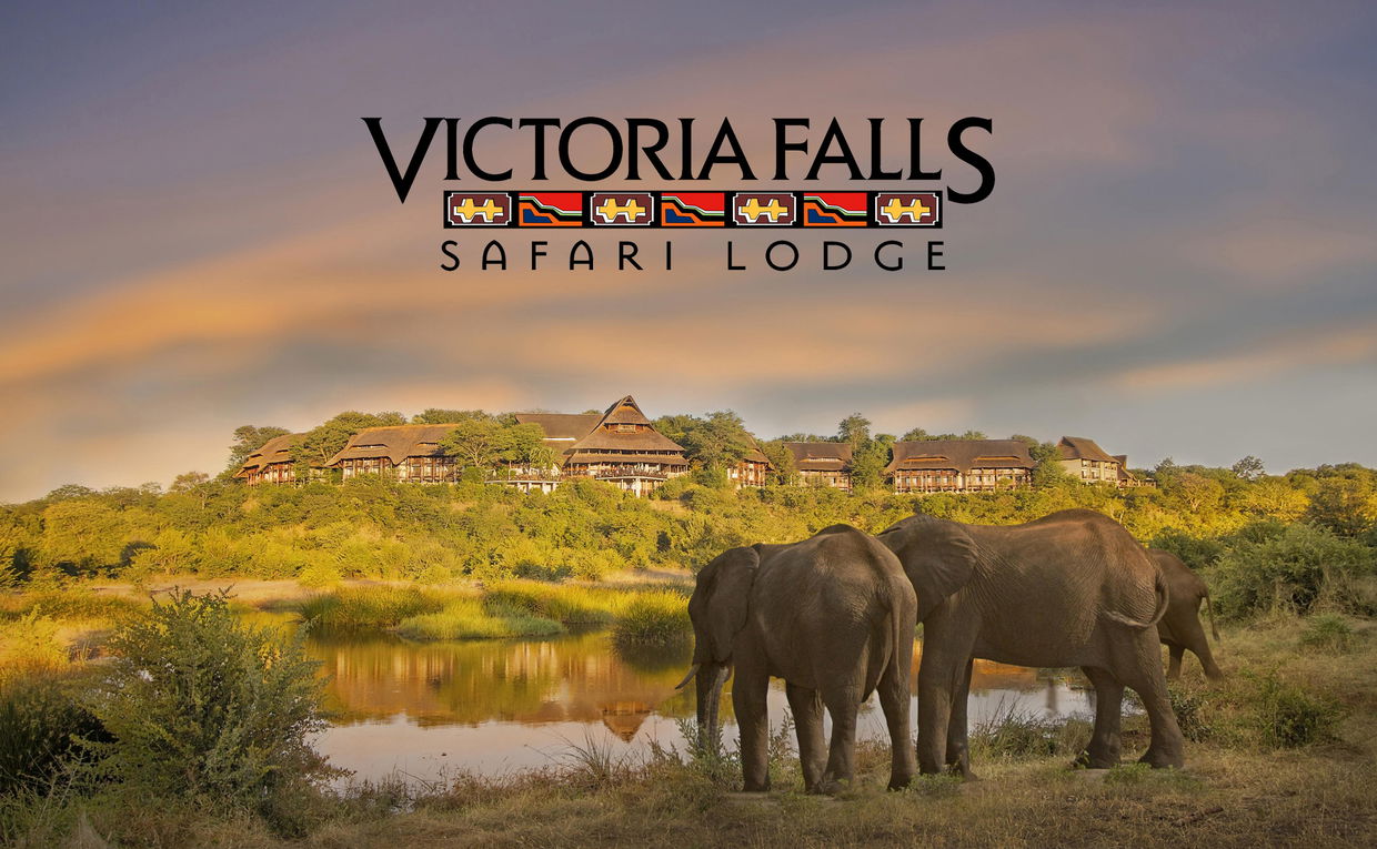water hole with elephants and view of lodge building at Victoria falls safari lodge Zimbabwe with logo overlay