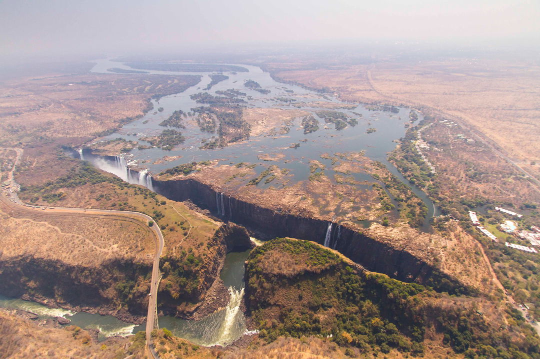 full width dry season ariel view of limited flow of Victoria falls Zimbabwe