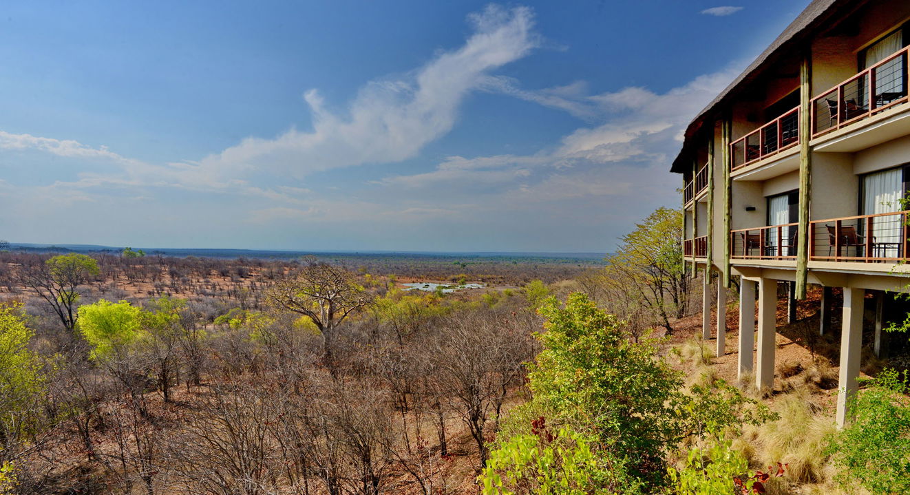 side view of Victoria falls safari lodge with waterhole in background