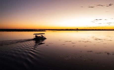 sunset cruise with barge on delta at wilderness duma tau camp botswana sunset cruise with barge on delta at wilderness duma tau camp botswana
