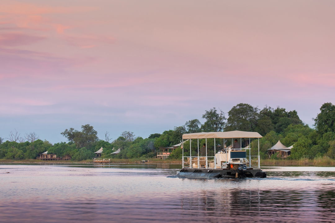 sunset barge cruise on delta by wilderness duma tau camp botswana