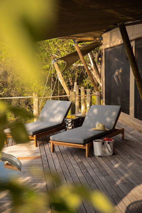 chairs on deck in front of suite by wilderness duma tau camp botswana