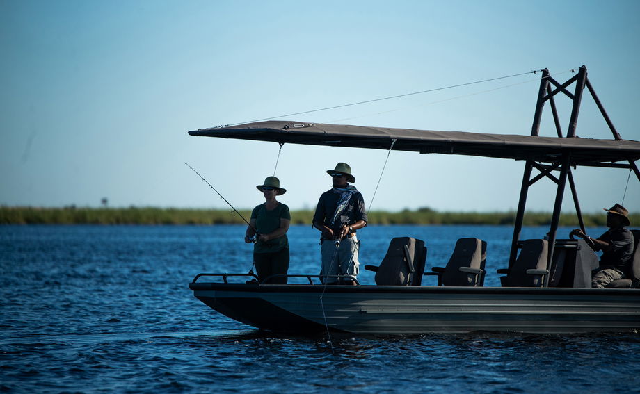 guests fishing on a boat of wilderness duma tau camp botswana