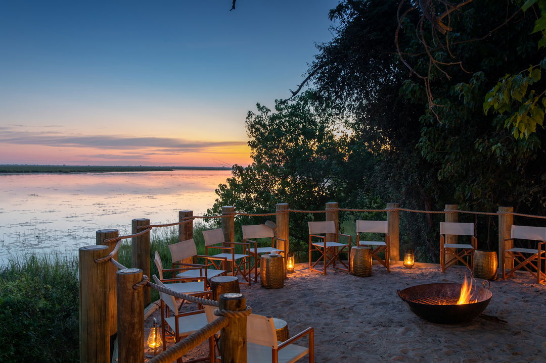 view of the firepit at sunset by wilderness duma tau camp botswana