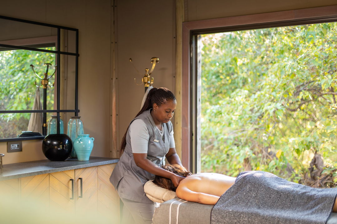 lady guest getting a message in osprey spa of wilderness duma tau camp botswana