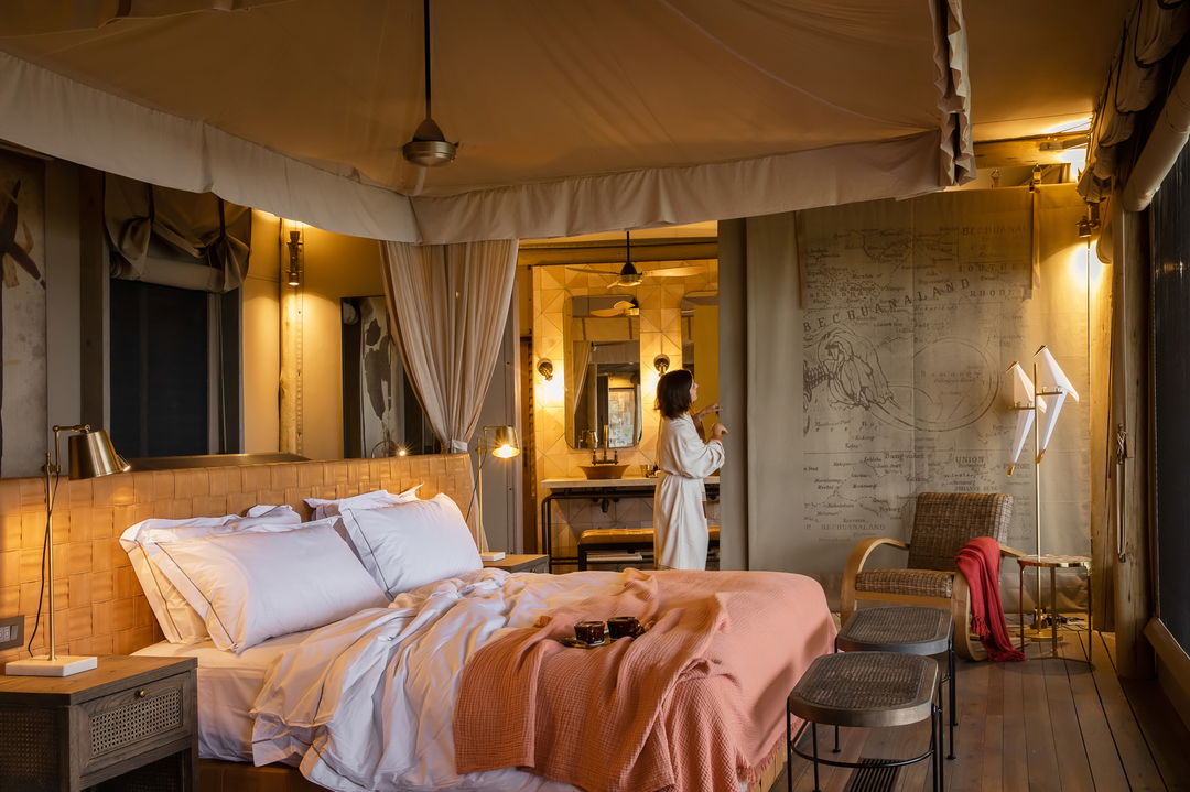 guest in bedroom of standard suite of wilderness duma tau camp botswana