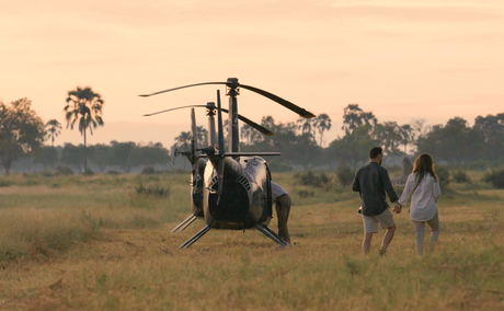 two guests at little Mombo Wilderness Okavango delta next to helicopters grounded two guests at little Mombo Wilderness Okavango delta next to helicopters grounded