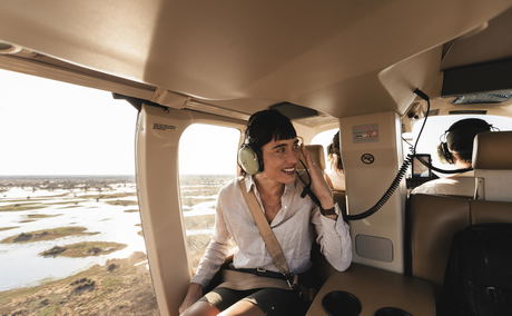 lady guest inside chopper over Okavango delta at Jao Camp Wilderness Botswana lady guest inside chopper over Okavango delta at Jao Camp Wilderness Botswana