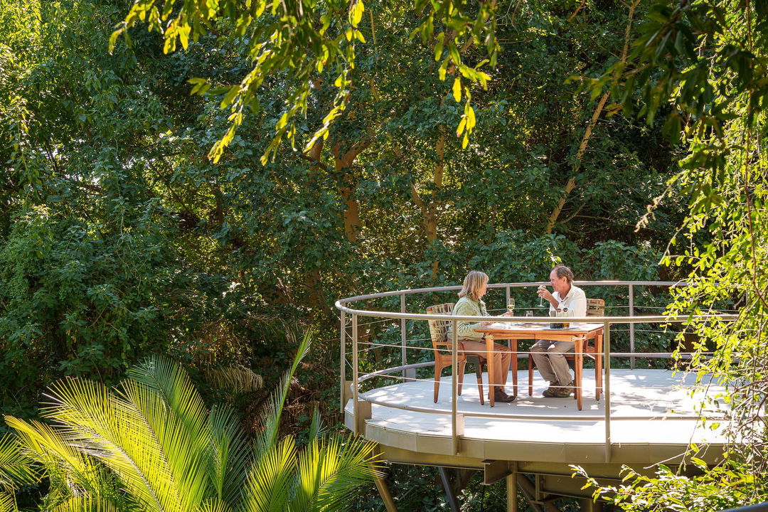 couple on deck of suite having private lunch at Jao Camp Wilderness Botswana