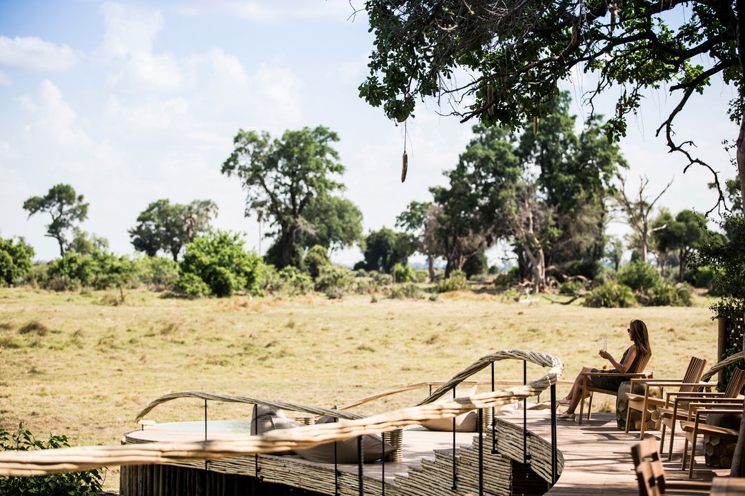 guest on suite deck with delta views at Little mombo camp Wilderness