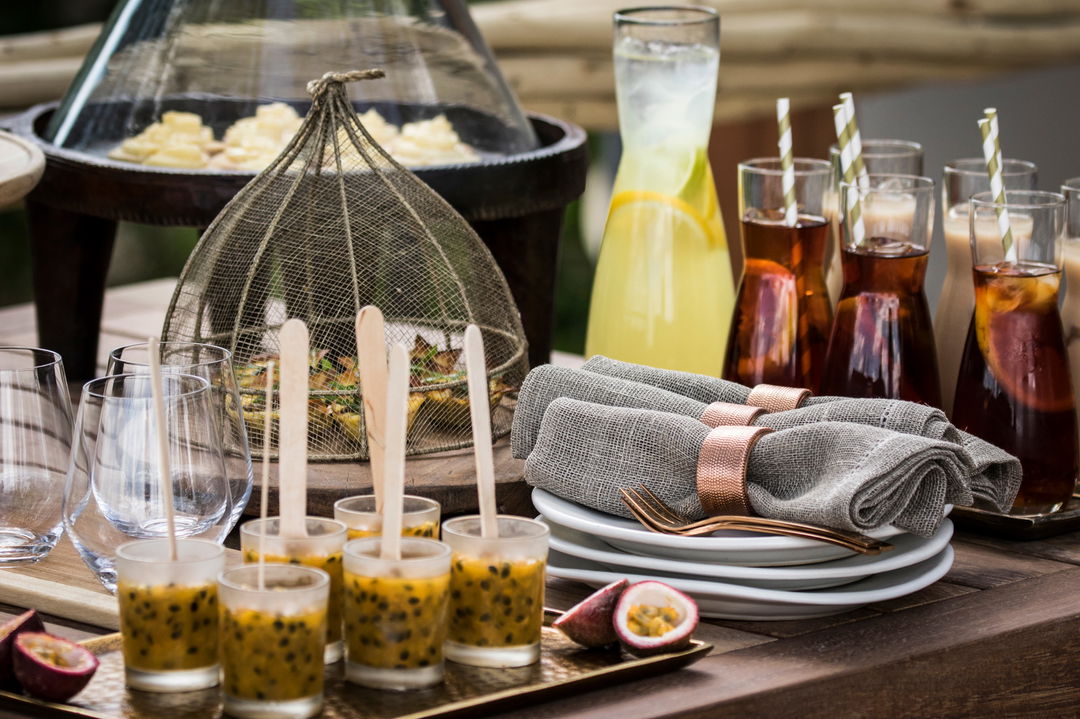 treats and desert on table display on deck at Okavango Delta by Little Mombo Wilderness