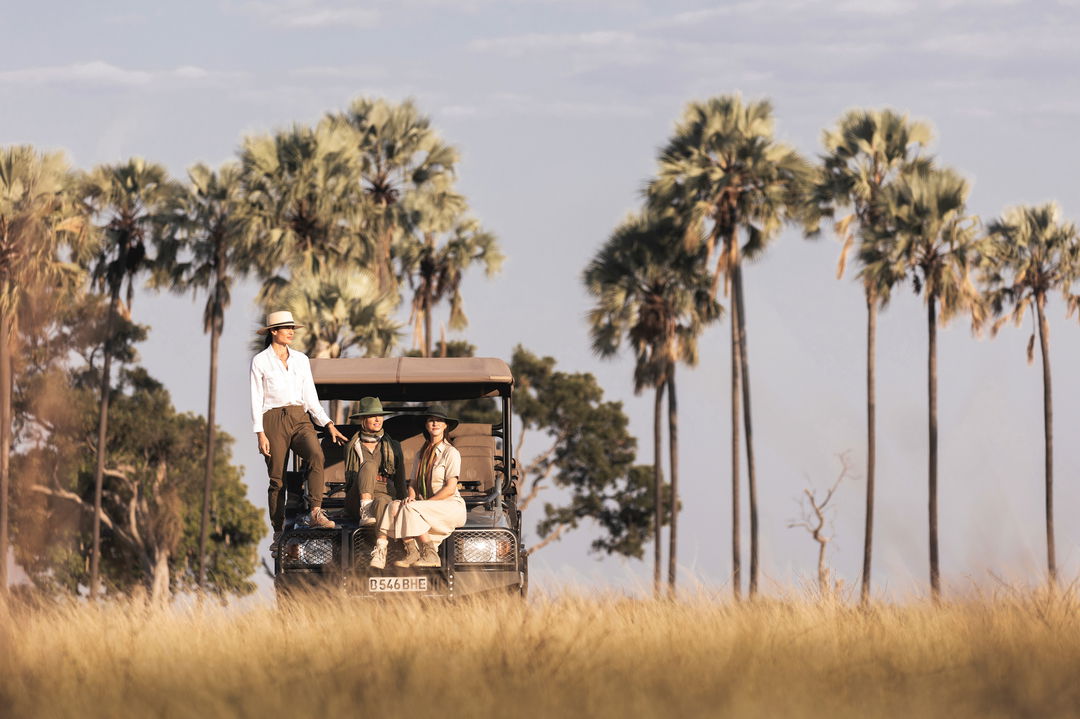 guests on open game viewing vehicle with guests in Okavango Delta by Little Mombo Wilderness