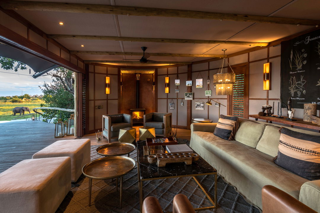 suite lounge area with luxurious leather couches at Little Mombo Wilderness
