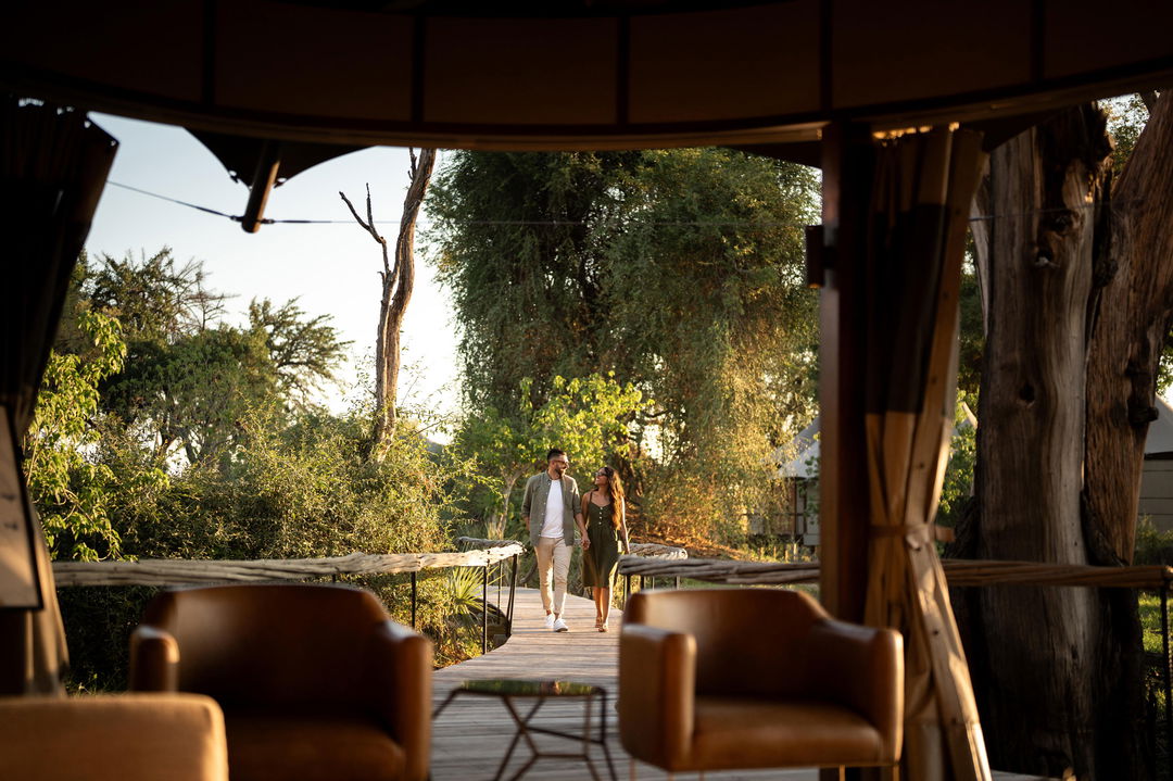 outside deck with guests at Wilderness Mombo Camp in the Okavango Delta