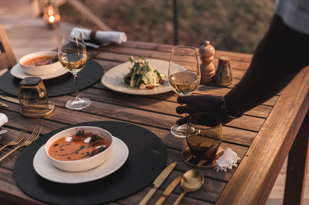 two plates with gourmet cousine served at Wilderness Mombo Camp