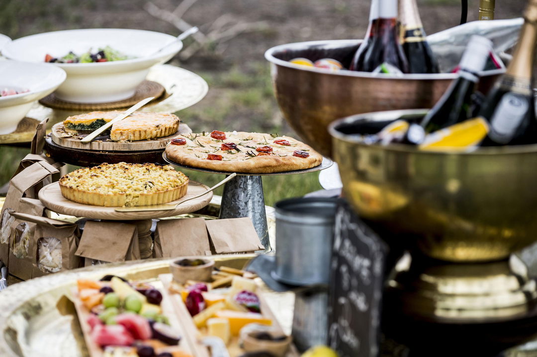 food and wine spread on a table at Wilderness Mombo Camp Okavango Delta