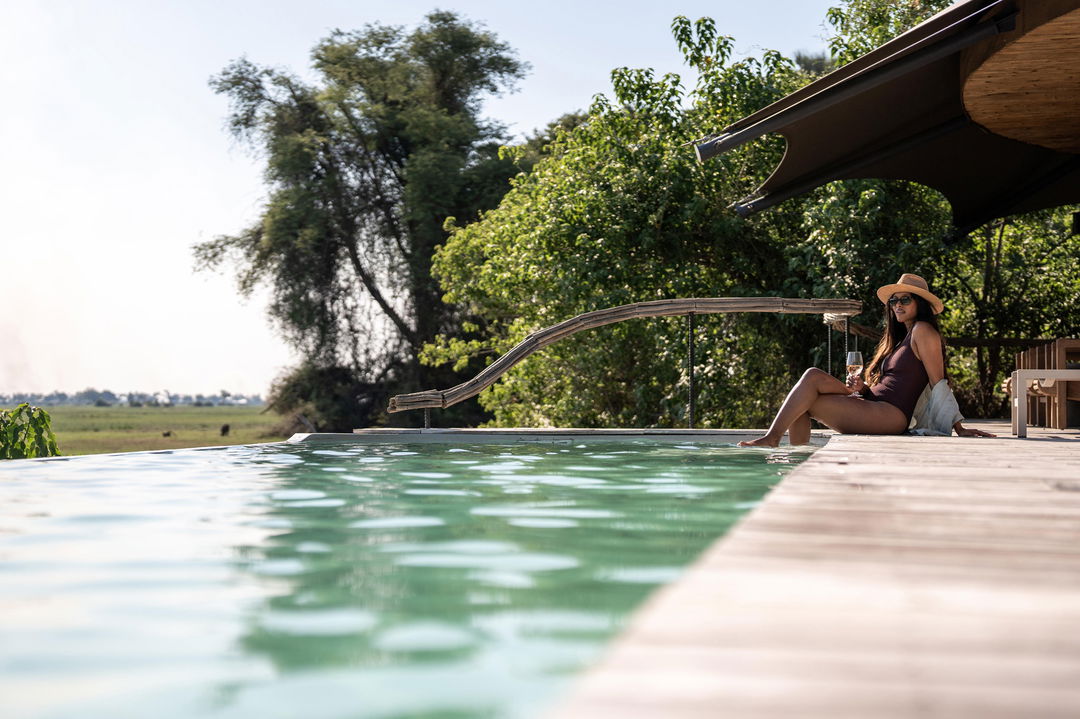 guest at pool at Wilderness Mombo Camp in the Okavango Delta