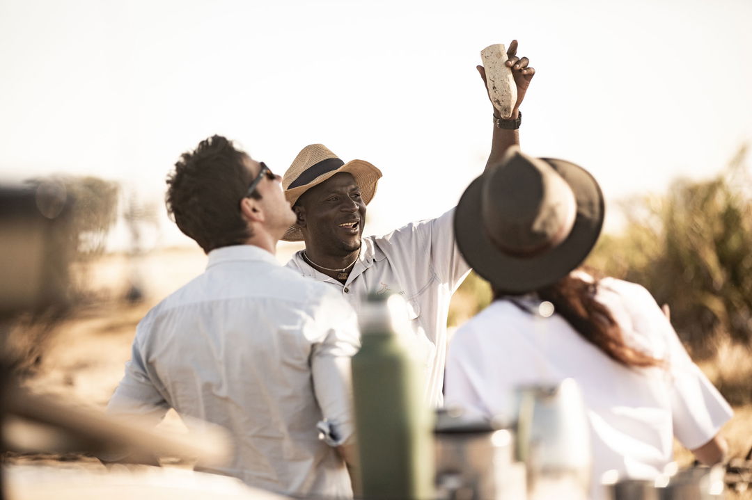 guide educating guests on walking safari at Jao Camp Wilderness Okavango Delta Botswana