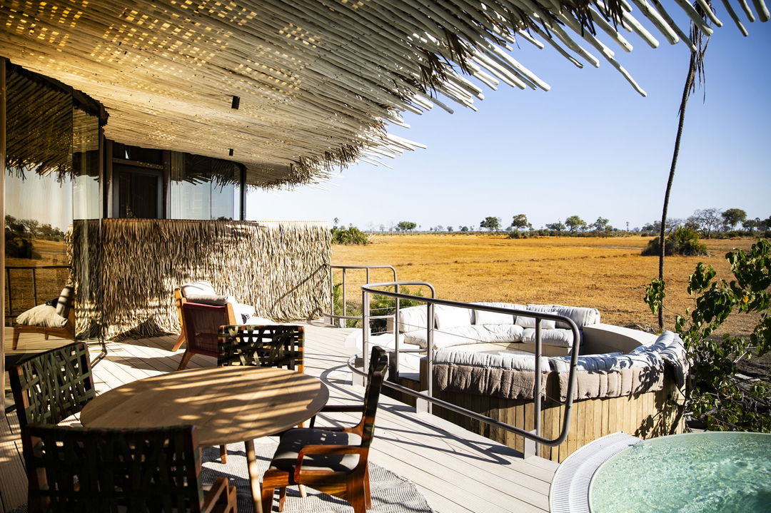 viewing deck with table and chairs and pool in background at Jao Camp Botswana