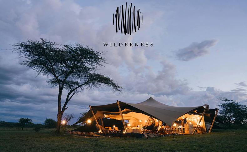 sunset exterior view of Wilderness Usawa tented camp Serengeti with logo overlay sunset exterior view of Wilderness Usawa tented camp Serengeti with logo overlay